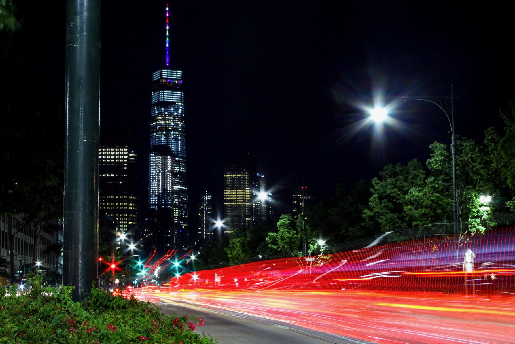 Nighttime Manhattan avenue with vivid red light trails